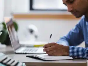 A migrant using immiaccount for a visa application on a laptop