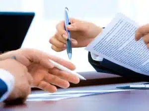Close up image of a lawyer writing the Medicare eligibility requirements for a partner or bridging visa