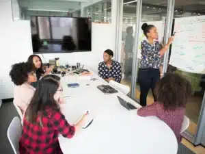 An immigration lawyer explaining explaining requirements for partner visa evidence to a group of female migrants