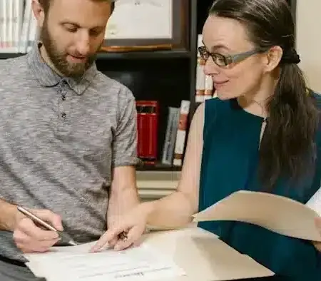 An experienced partner visa lawyer discussing the Australian migration process with a client